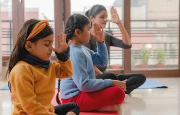 Children practising yoga and mindfulness at Neevalay