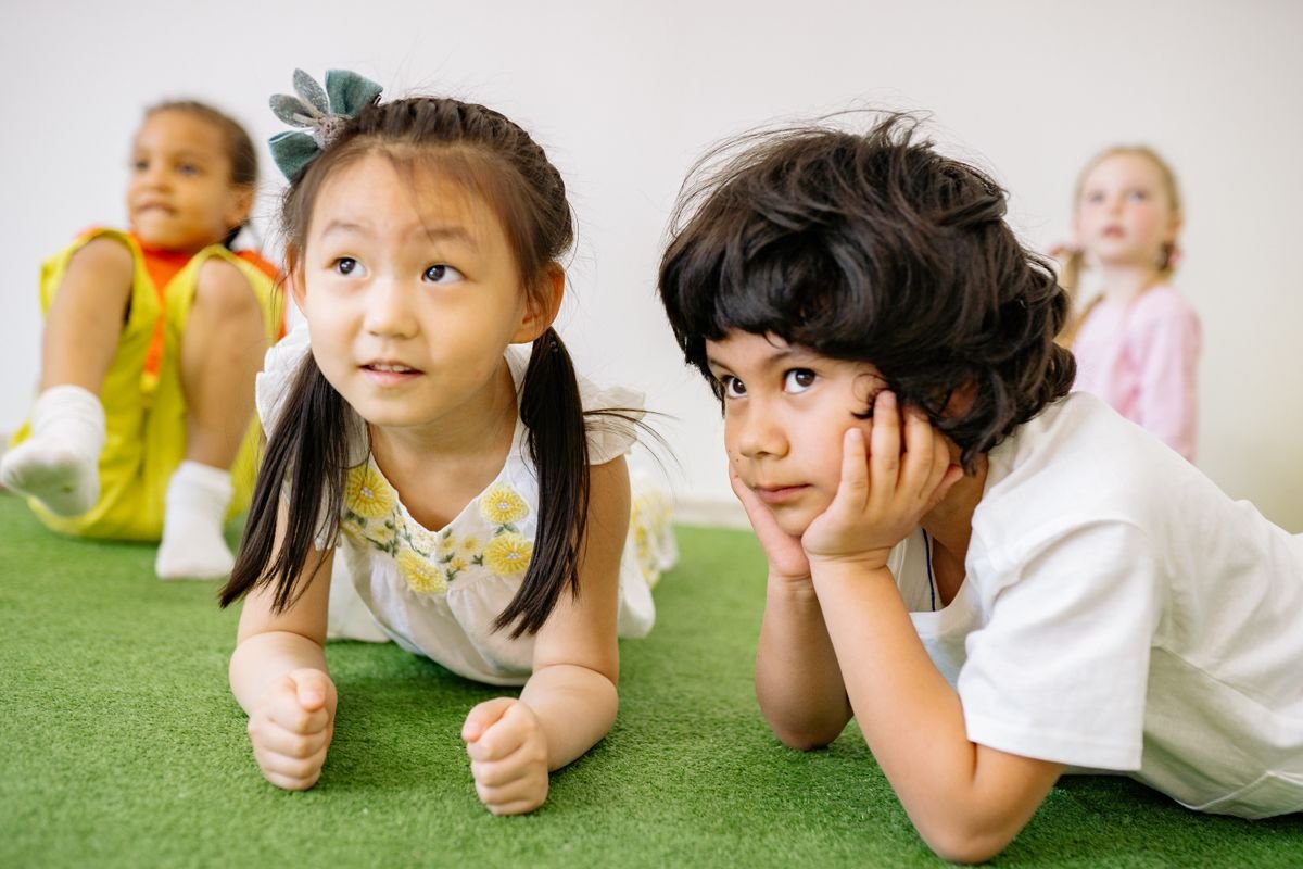 Two curious young children, attentive and engaged in a Neevalay learning space